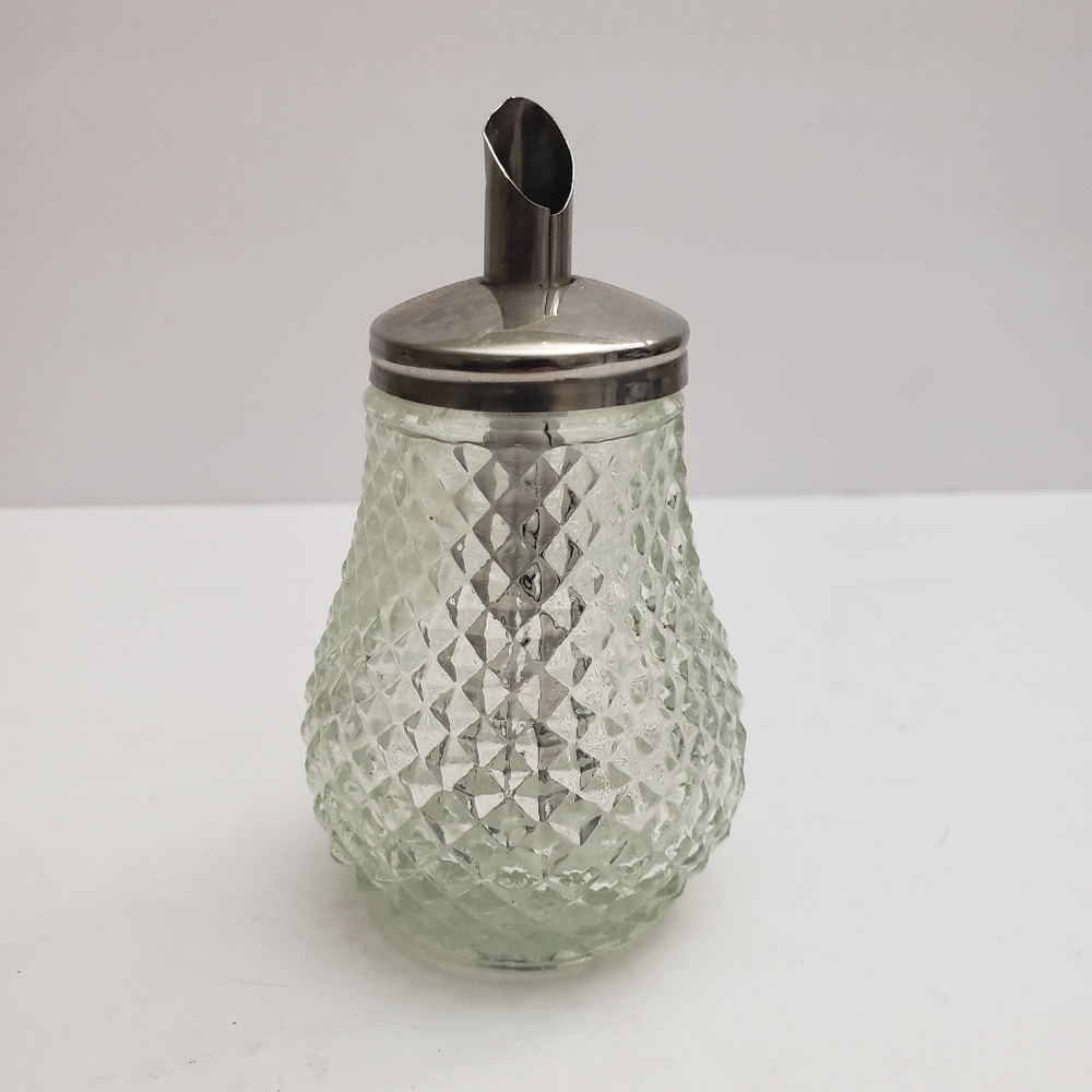 Glass sugar dispenser with a metal lid and spout. 206